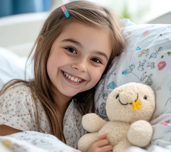 smiling girl with a stuffed animal