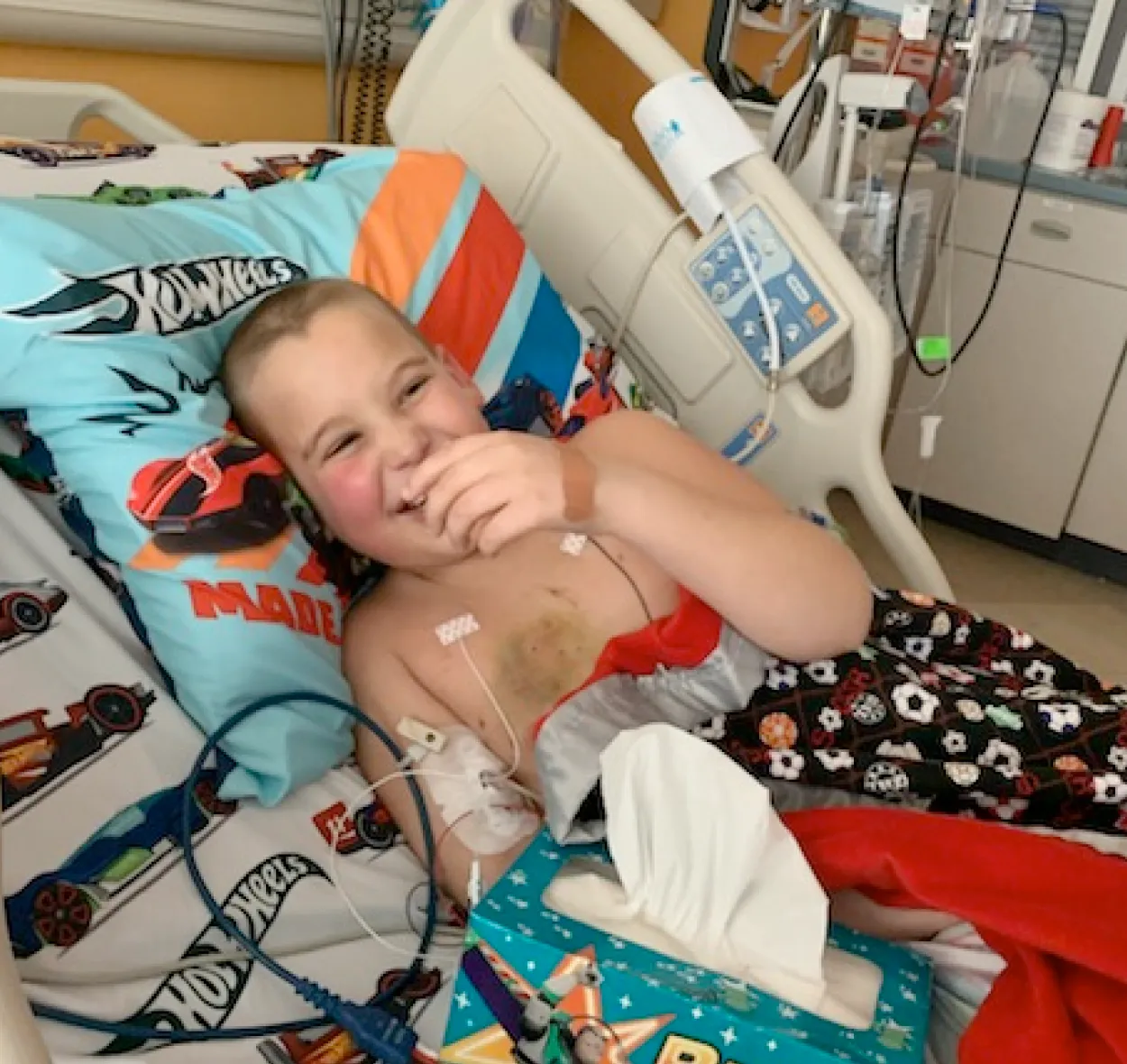 sawyer in a hospital bed smiling