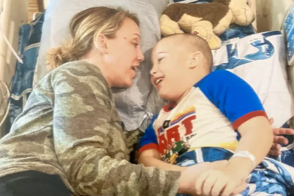 sawyer with his mom in a hospital bed